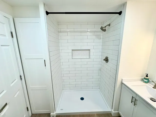 a bathroom with a shower and a sink