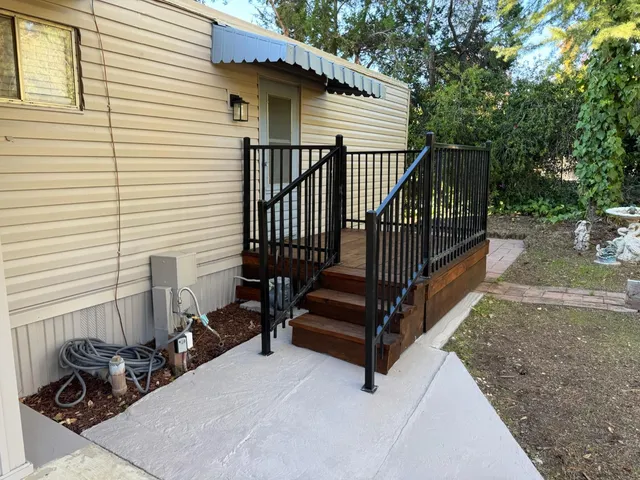 a view of backyard with deck and a garden