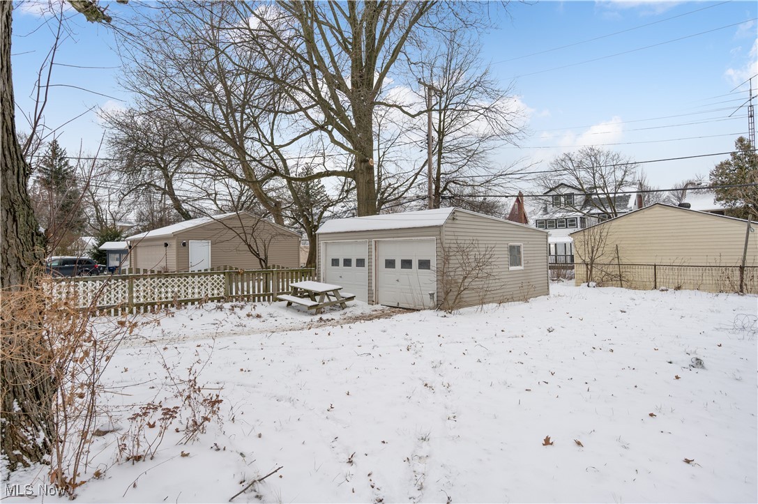 2016 Rossmoor Road Cleveland Heights, OH 44118 - Photo 45 of 46 Snowy yard featuring an outdoor structure and a garage