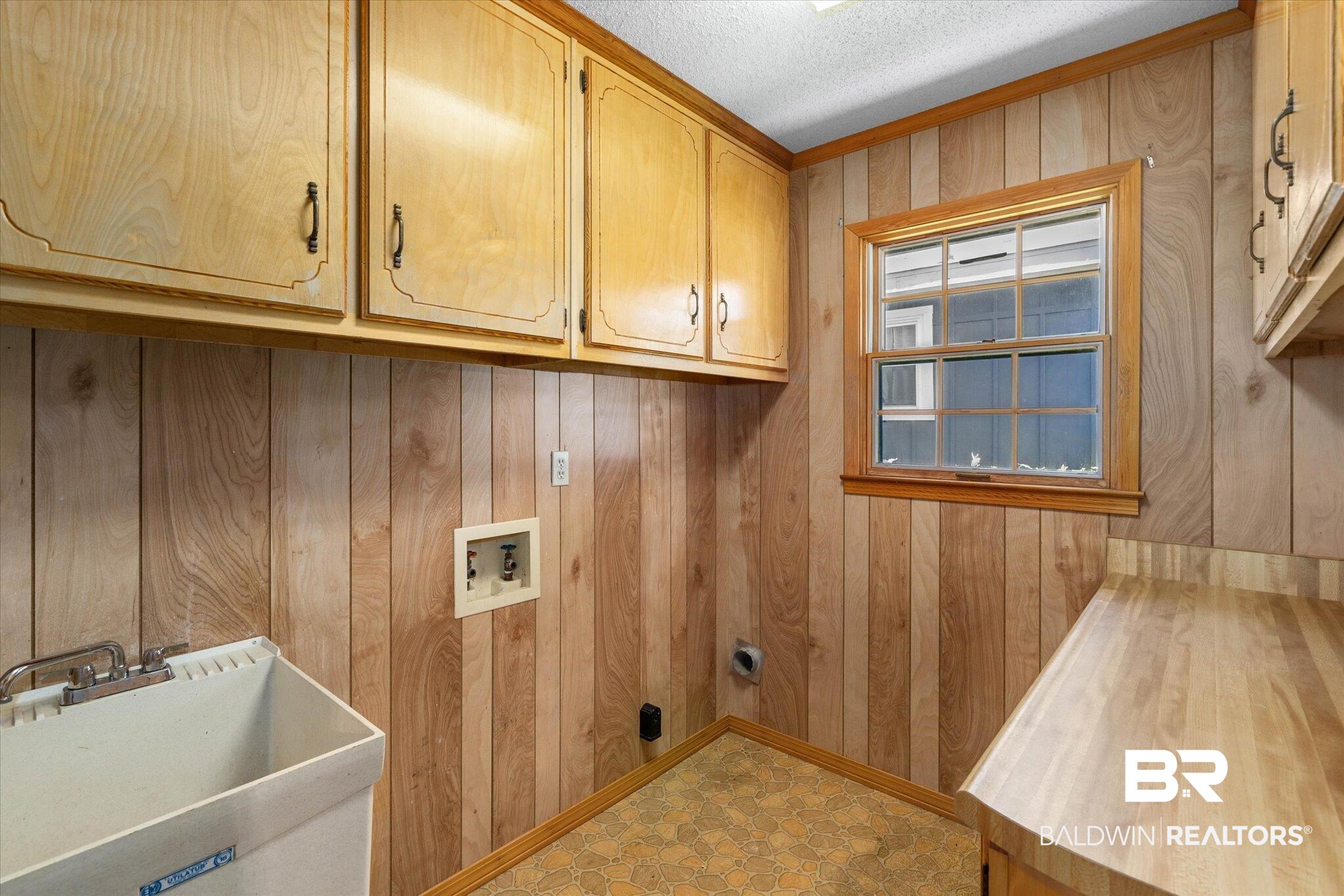 5503 Darring Street Satsuma, AL 36572 - Photo 26 of 31 Laundry room with cabinet space, hookup for a washing machine, wood walls, a textured ceiling, and tile patterned floors
