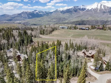 a view of a town with mountains in the background