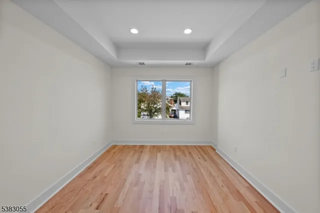 a view of room with window and wooden floor