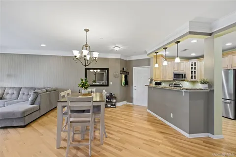 a living room with kitchen island furniture and a chandelier