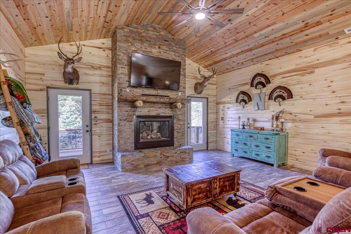 1798 Ranchland Drive Pagosa Springs, CO 81147 - Photo 17 of 45 a living room with furniture a flat screen tv and a fireplace