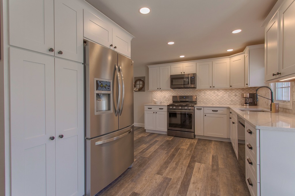 13 Golf Avenue, Unit 13 Methuen, MA 01844 - Photo 12 of 30 a kitchen with stainless steel appliances a refrigerator sink and microwave
