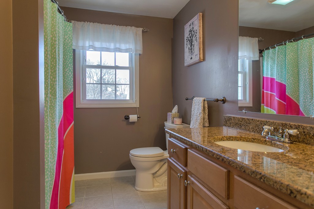 13 Golf Avenue, Unit 13 Methuen, MA 01844 - Photo 14 of 30 a bathroom with a granite countertop toilet sink and mirror