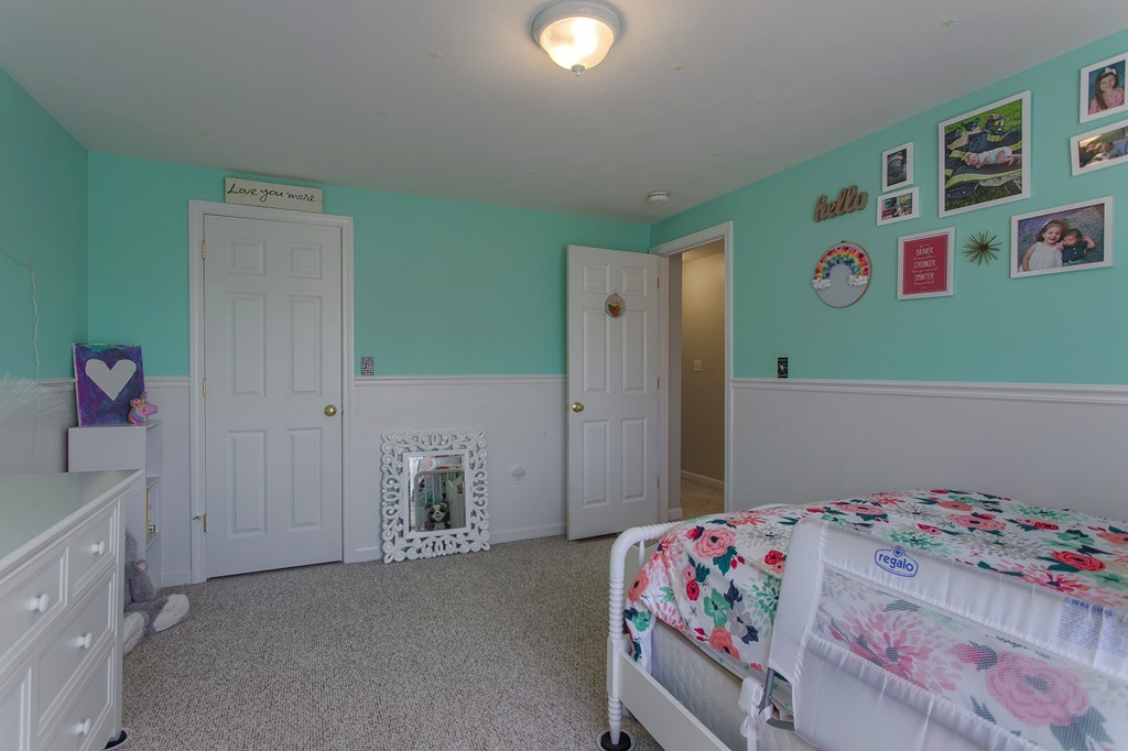 13 Golf Avenue, Unit 13 Methuen, MA 01844 - Photo 16 of 30 a bedroom with a bed and a dresser in it