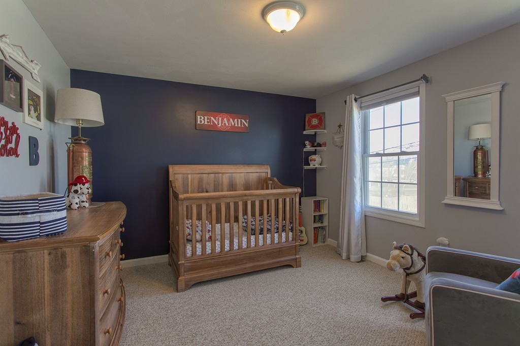 13 Golf Avenue, Unit 13 Methuen, MA 01844 - Photo 17 of 30 a bedroom with a baby bed a couch and a window