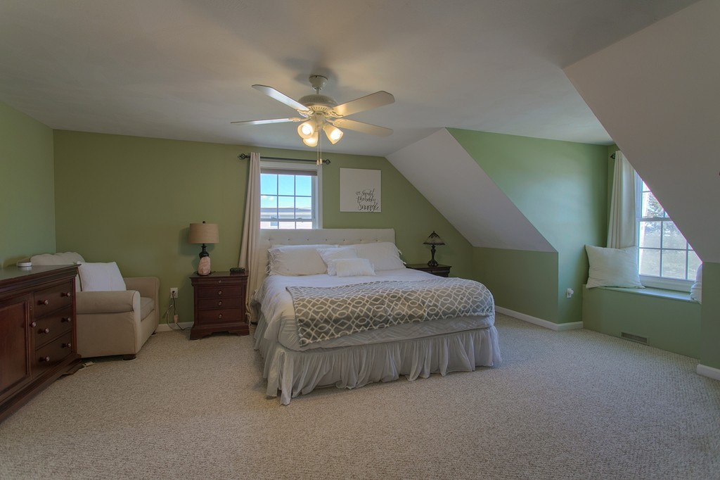 13 Golf Avenue, Unit 13 Methuen, MA 01844 - Photo 20 of 30 a spacious bedroom with a bed and a chandelier