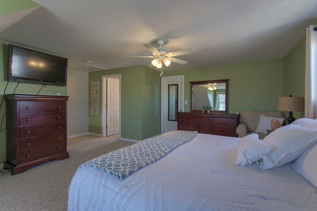 13 Golf Avenue, Unit 13 Methuen, MA 01844 - Photo 21 of 30 a bedroom with a bed and a flat tv screen on dresser