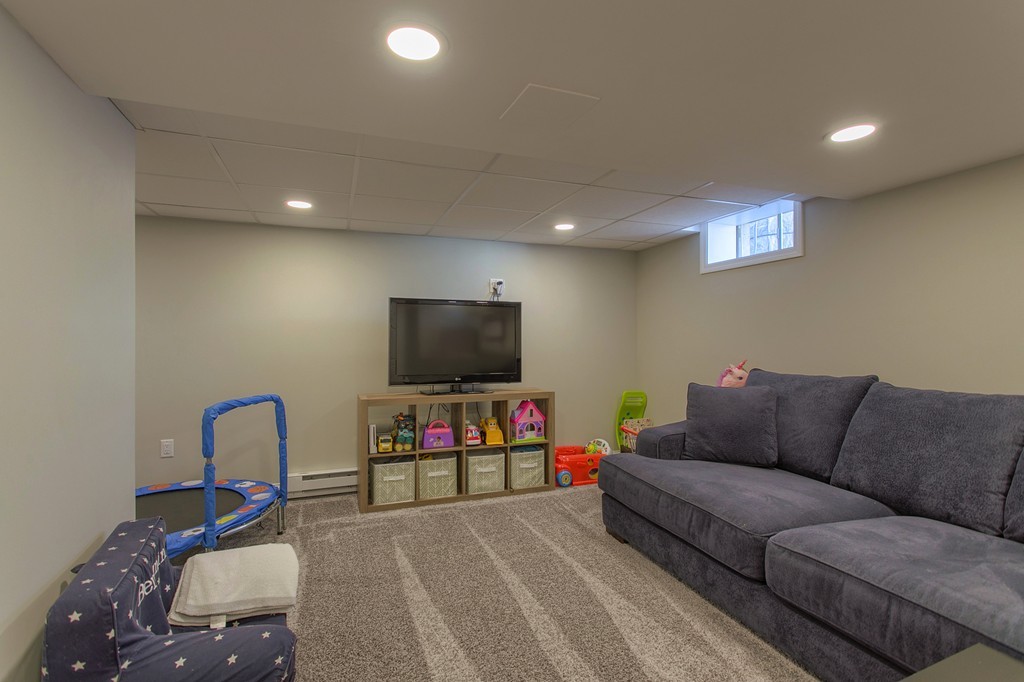 13 Golf Avenue, Unit 13 Methuen, MA 01844 - Photo 25 of 30 a living room with furniture and a flat screen tv