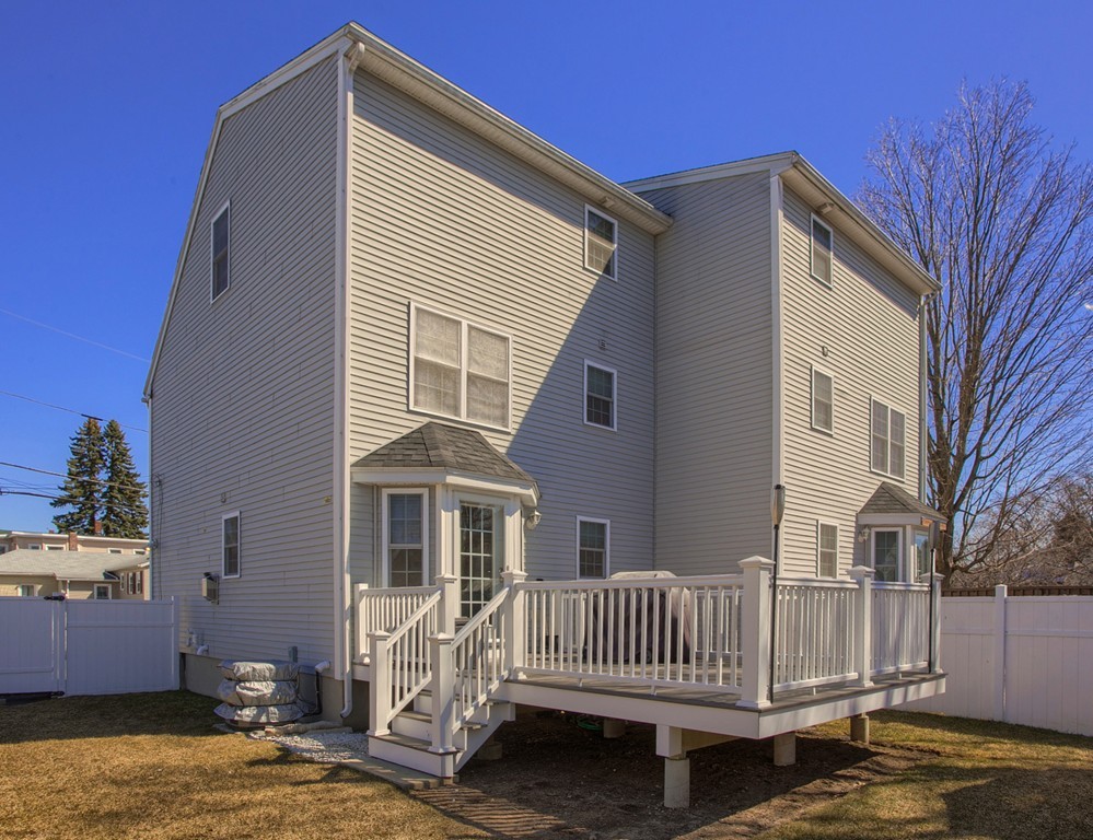 13 Golf Avenue, Unit 13 Methuen, MA 01844 - Photo 28 of 30 a front view of a house with garden and deck