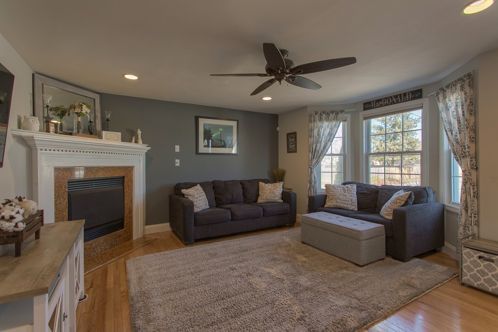 13 Golf Avenue, Unit 13 Methuen, MA 01844 - Photo 4 of 30 a living room with furniture and a fireplace