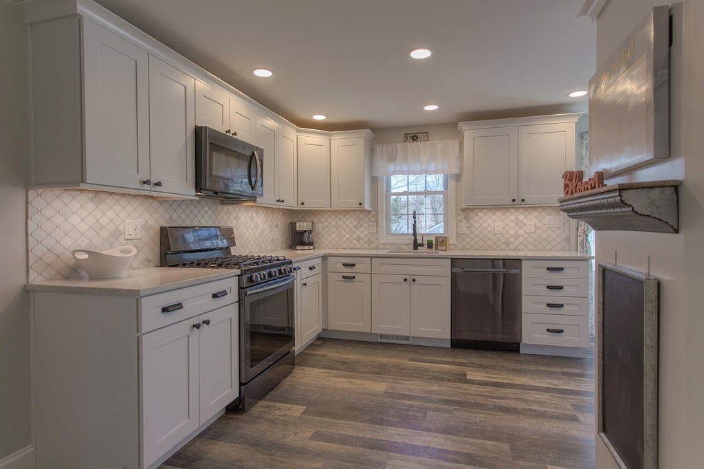 13 Golf Avenue, Unit 13 Methuen, MA 01844 - Photo 6 of 30 a kitchen with stainless steel appliances granite countertop a stove a sink and a microwave