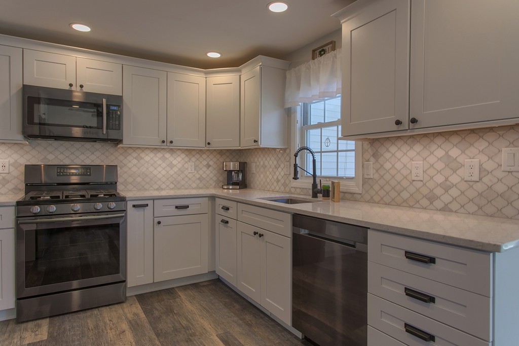 13 Golf Avenue, Unit 13 Methuen, MA 01844 - Photo 8 of 30 a kitchen with granite countertop white cabinets stainless steel appliances and a sink