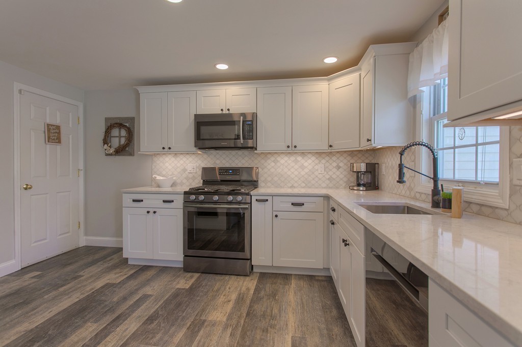 13 Golf Avenue, Unit 13 Methuen, MA 01844 - Photo 9 of 30 a kitchen with stainless steel appliances a sink cabinets and a stove top oven