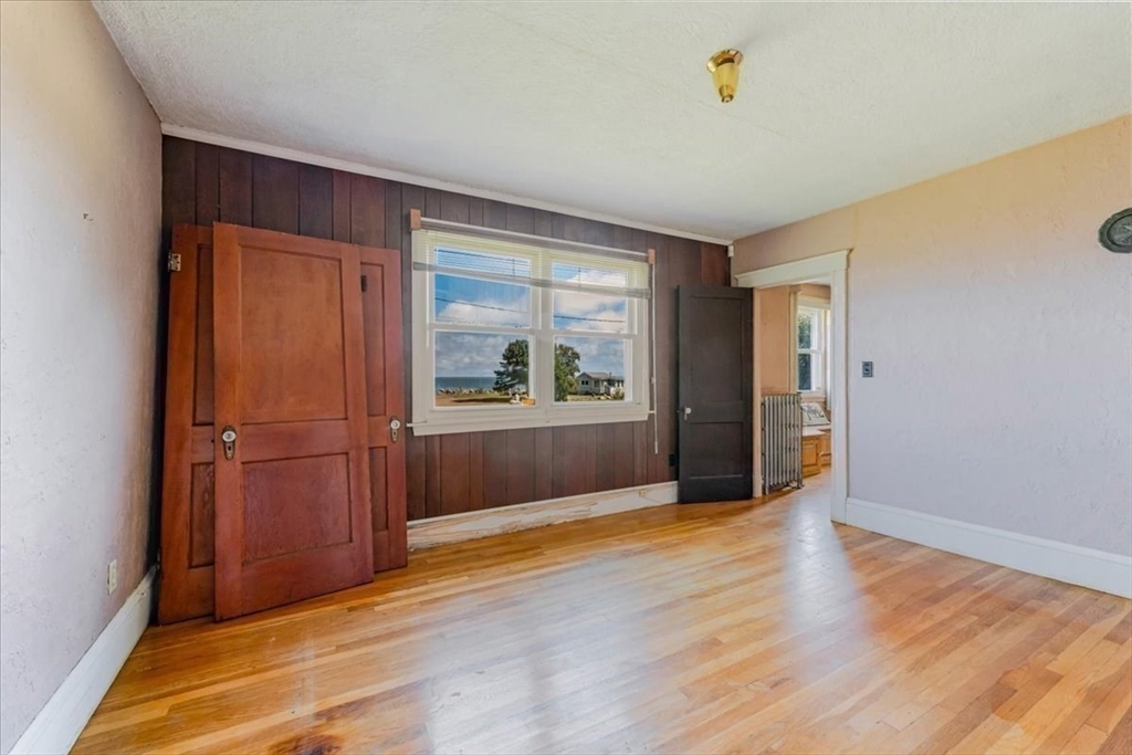 70 Hedge Road Plymouth, MA 02360 - Photo 25 of 41 a view of an empty room with wooden floor and a window