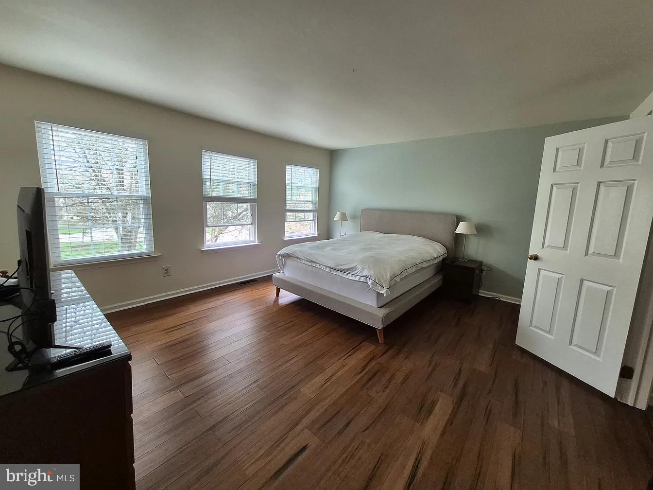 262 Tulip Tree Court Blue Bell, PA 19422 - Photo 24 of 32 a bedroom with a bed and wooden floor