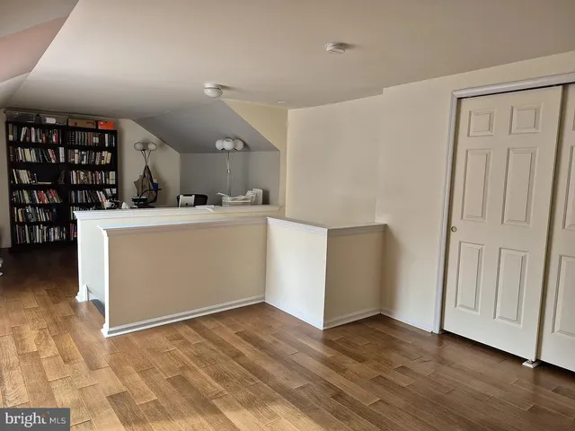 a view of a kitchen with wooden floor and electronic appliances