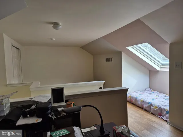 a bedroom with a bed and a piano