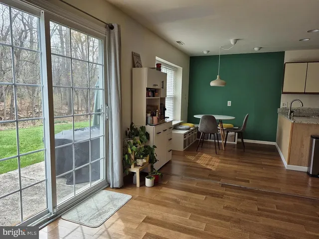 a view of a livingroom with furniture wooden floor and a floor to ceiling window