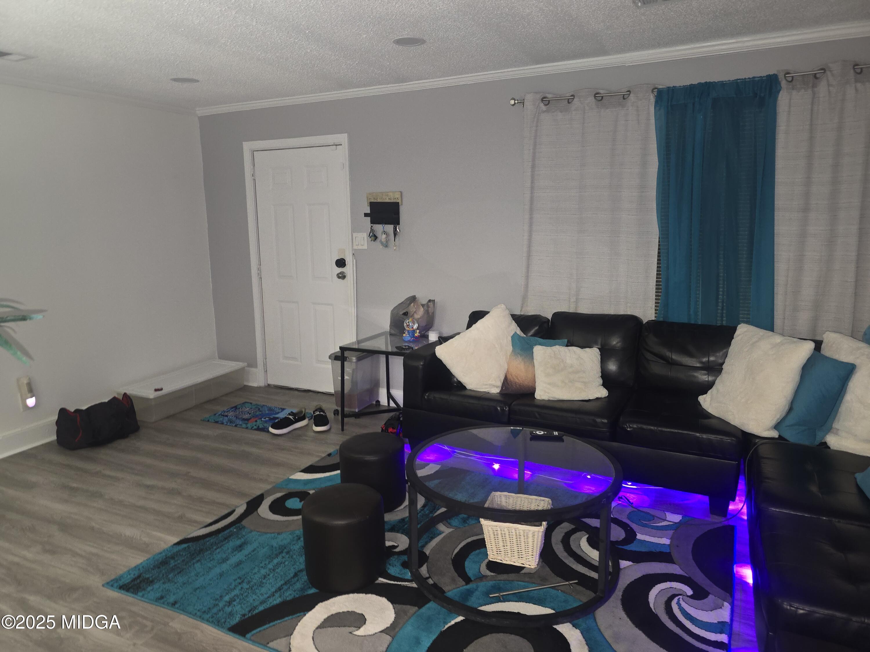 2420 Adams Avenue Macon, GA 31206 - Photo 3 of 5 a living room with furniture and a wooden floor