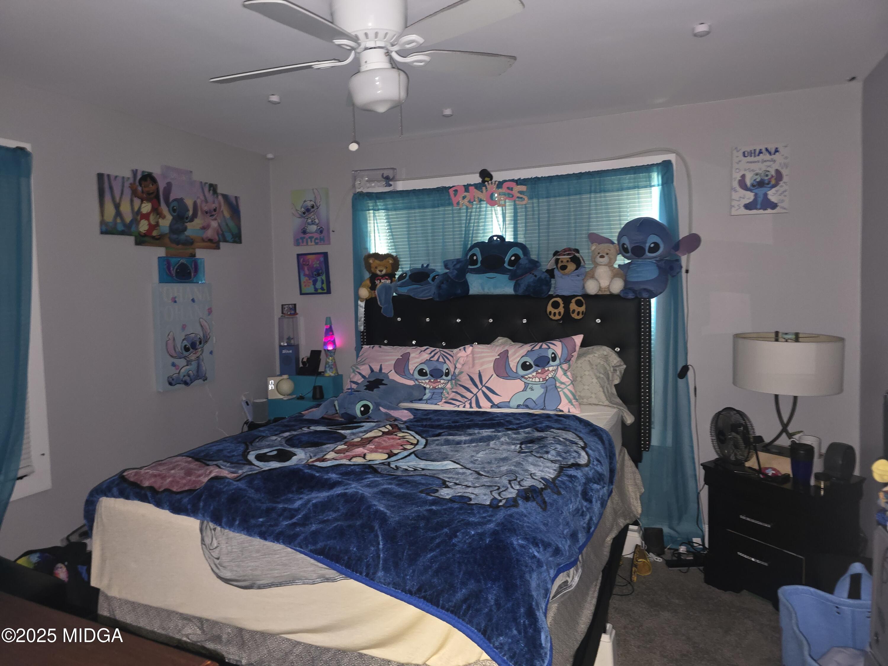 2420 Adams Avenue Macon, GA 31206 - Photo 4 of 5 a bed room with a bed mirror and a chair