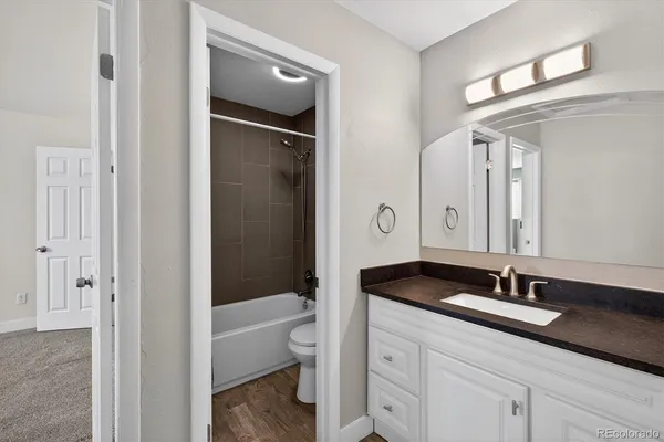 a bathroom with a double vanity sink and mirror with shower