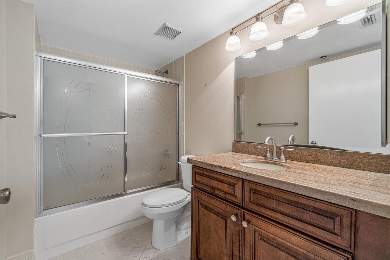 6530 Boca Del Mar Drive, Unit 336 Boca Raton, FL 33433 - Photo 16 of 22 a bathroom with a sink a toilet and shower