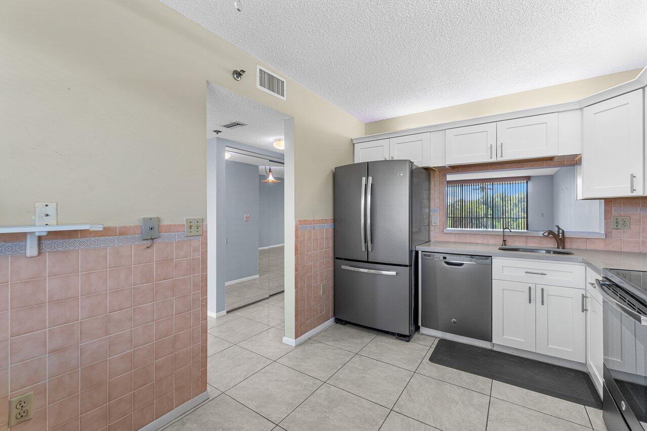 6530 Boca Del Mar Drive, Unit 336 Boca Raton, FL 33433 - Photo 18 of 22 a kitchen with cabinets and stainless steel appliances