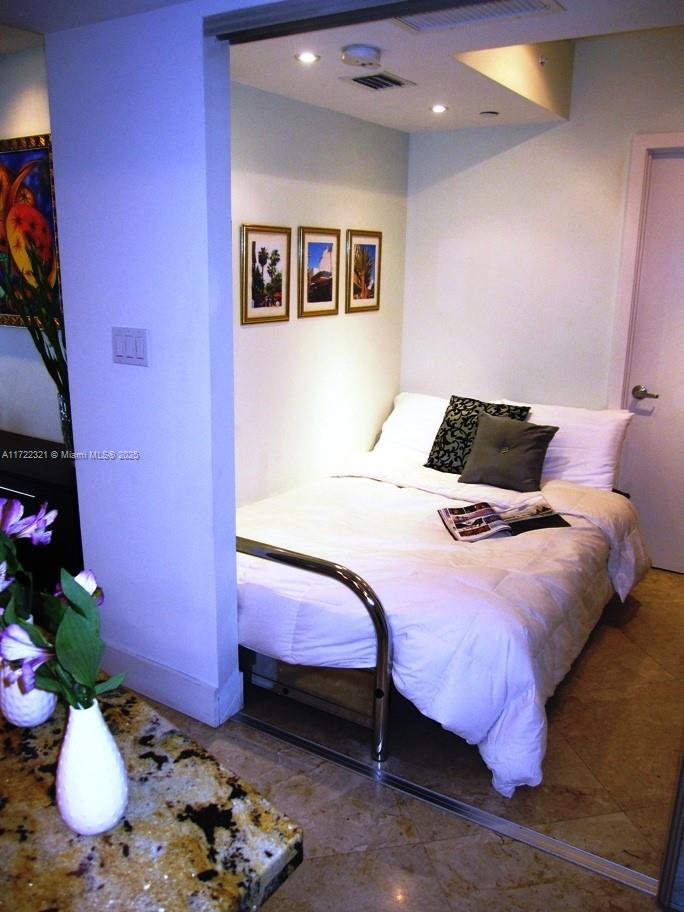 100 Lincoln Road, Unit 444 Miami Beach, FL 33139 - Photo 11 of 18 a bedroom with a bed and chandelier