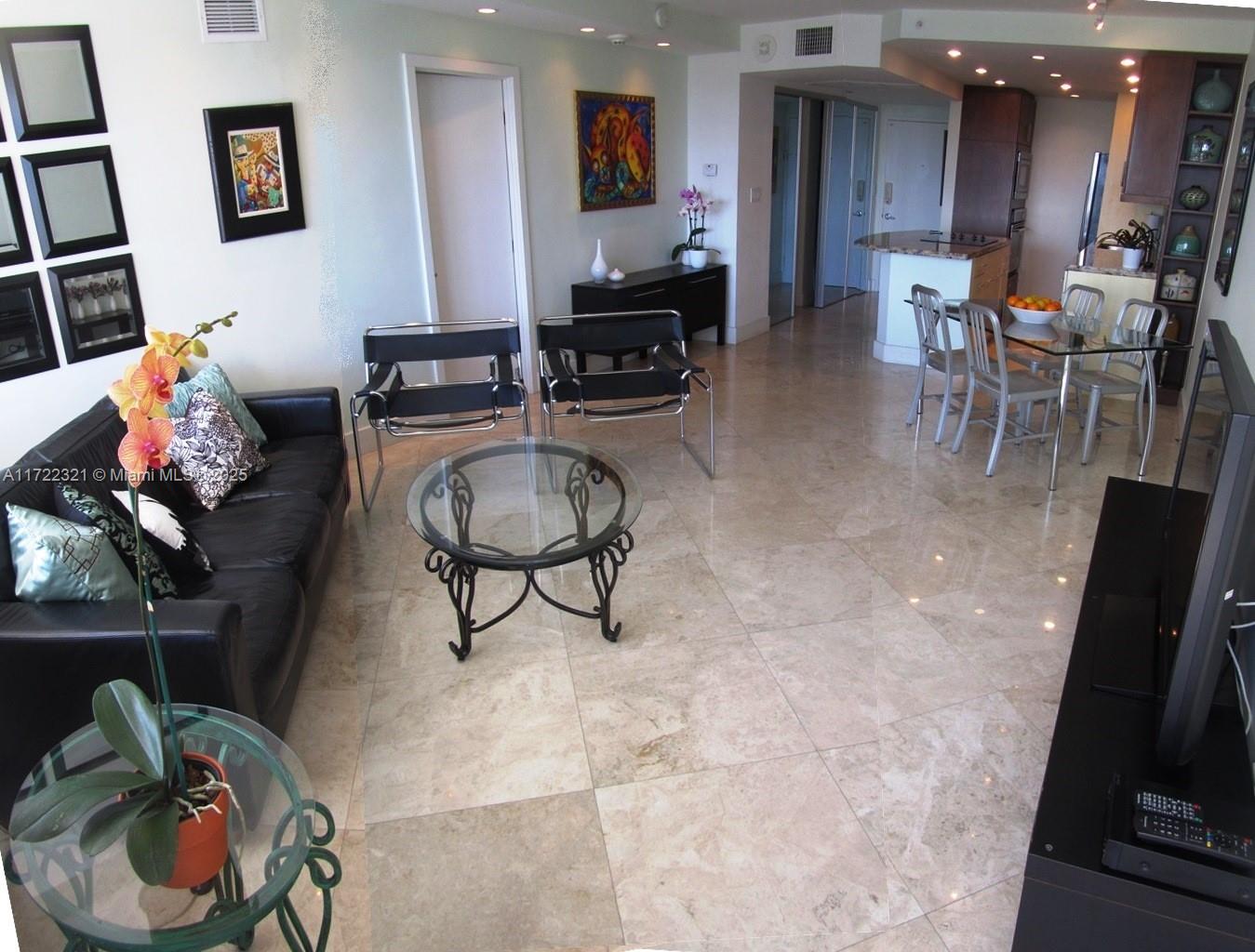 100 Lincoln Road, Unit 444 Miami Beach, FL 33139 - Photo 4 of 18 a living room with furniture and a flat screen tv