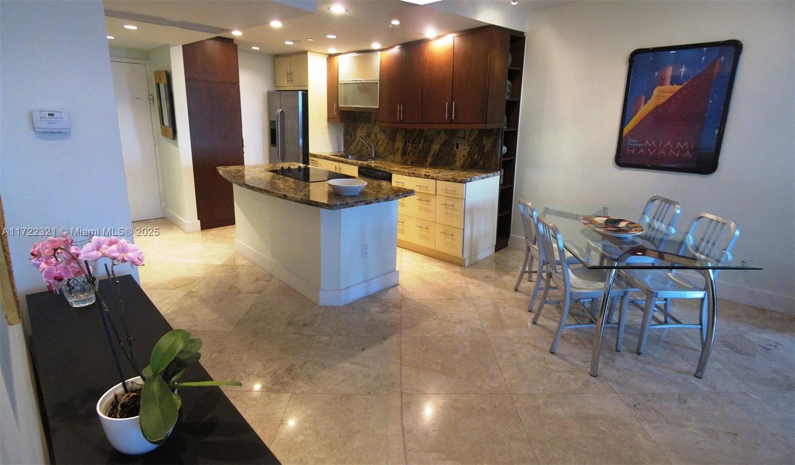 100 Lincoln Road, Unit 444 Miami Beach, FL 33139 - Photo 6 of 18 a kitchen with stainless steel appliances granite countertop a refrigerator and a stove