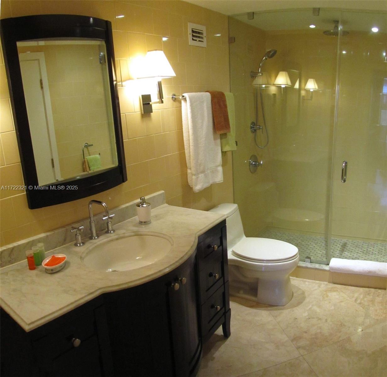 100 Lincoln Road, Unit 444 Miami Beach, FL 33139 - Photo 7 of 18 a bathroom with a double vanity sink toilet and shower