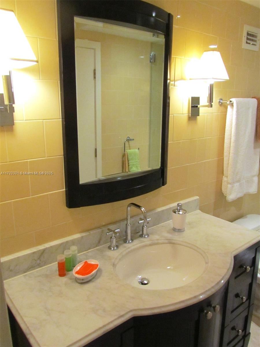 100 Lincoln Road, Unit 444 Miami Beach, FL 33139 - Photo 8 of 18 a bathroom with a sink and a mirror
