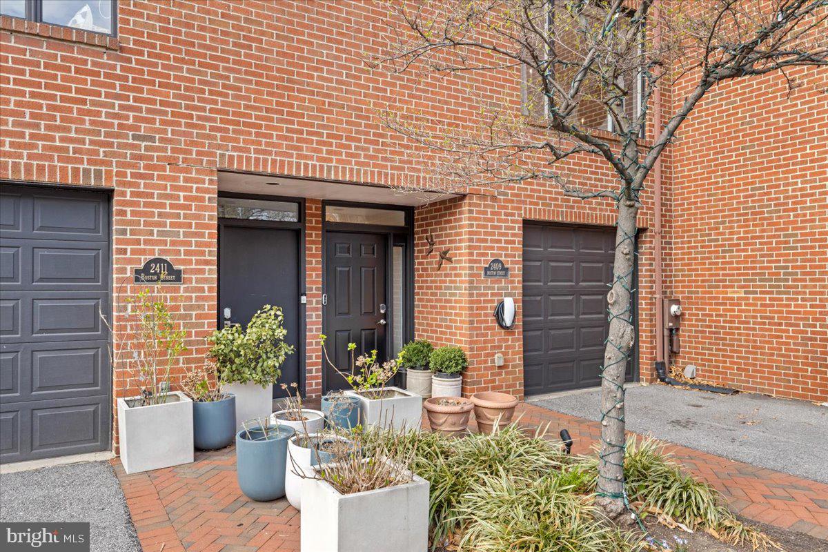 2409 Boston Street Baltimore, MD 21224 - Photo 11 of 46 a front view of a house with potted plants
