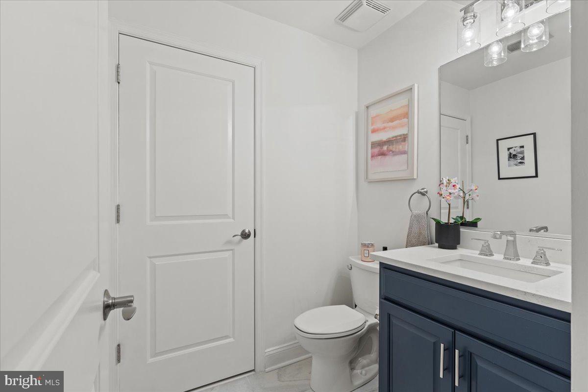 2409 Boston Street Baltimore, MD 21224 - Photo 13 of 46 a bathroom with a sink toilet and vanity