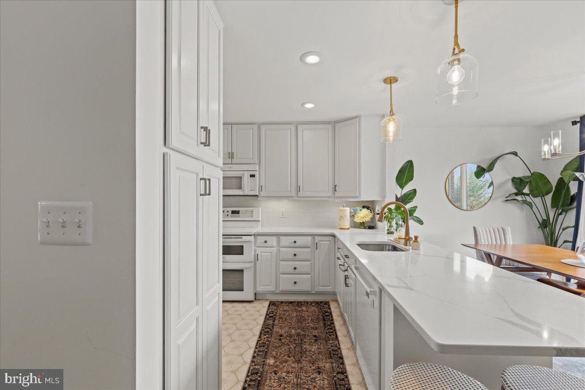 2409 Boston Street Baltimore, MD 21224 - Photo 16 of 46 a kitchen with kitchen island white cabinets appliances and cabinets