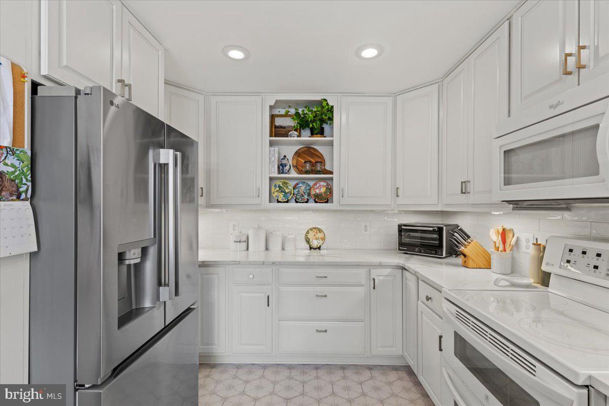 2409 Boston Street Baltimore, MD 21224 - Photo 17 of 46 a kitchen with stainless steel appliances granite countertop a refrigerator sink and cabinets