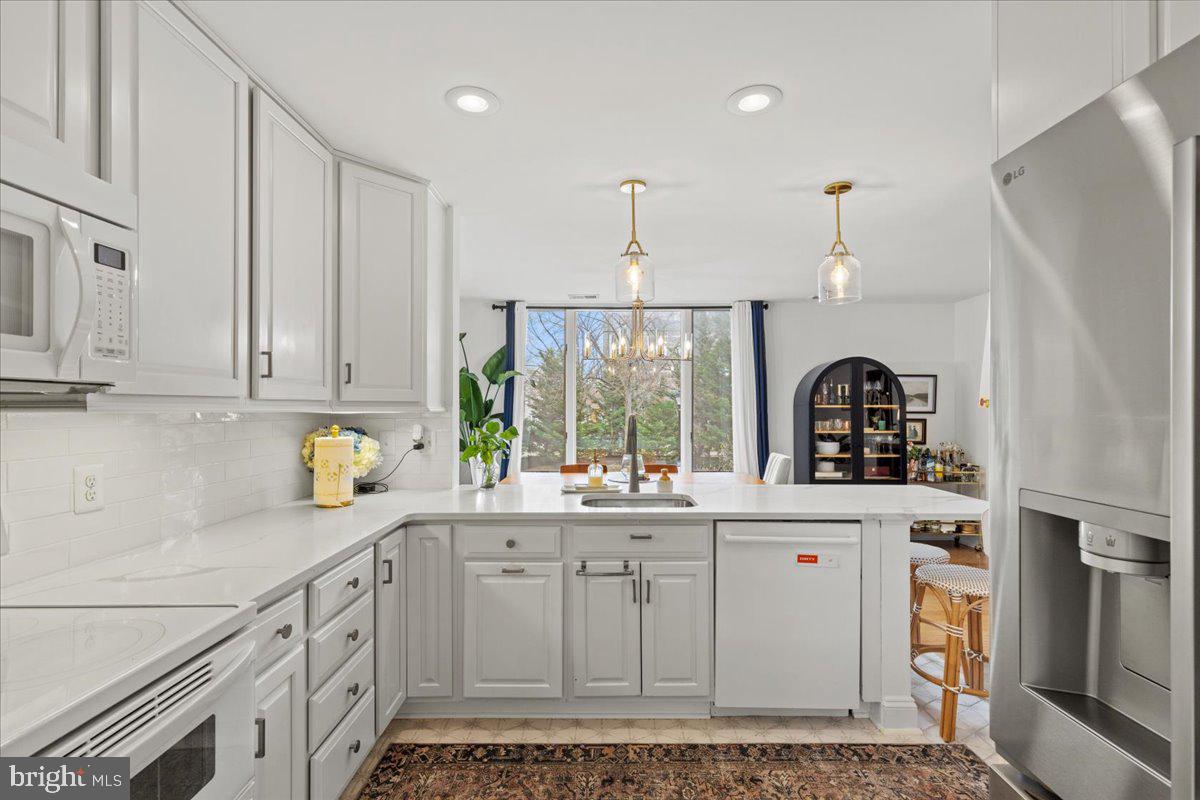 2409 Boston Street Baltimore, MD 21224 - Photo 18 of 46 a kitchen with stainless steel appliances a sink stove and cabinets