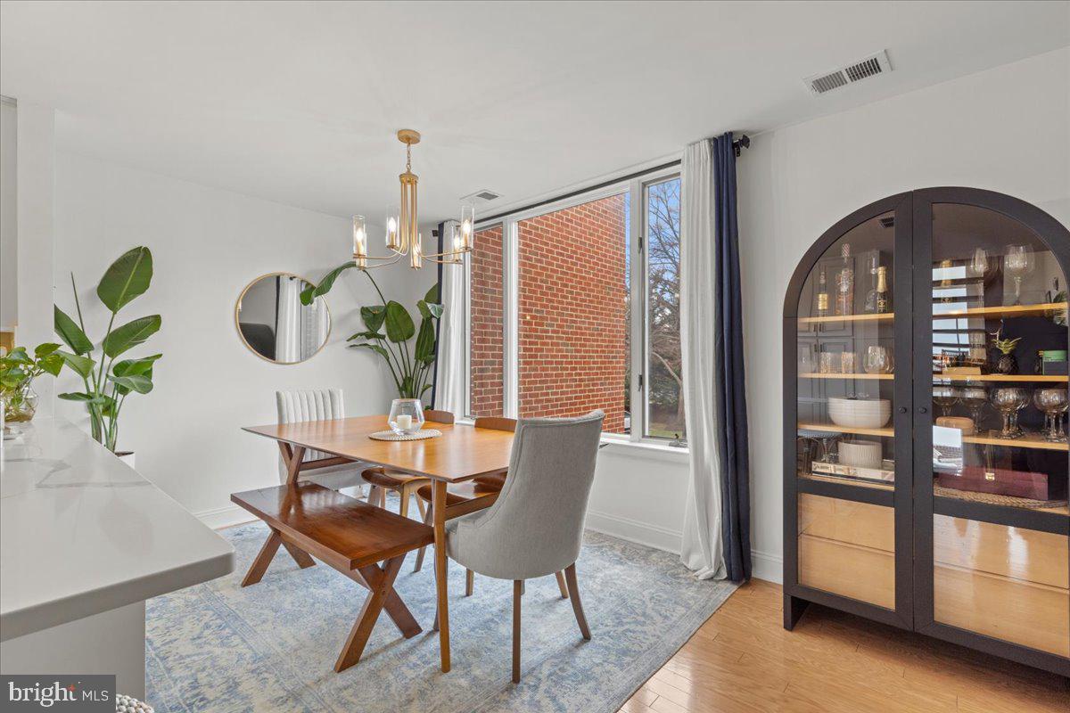 2409 Boston Street Baltimore, MD 21224 - Photo 20 of 46 a dining room with furniture a rug and a potted plant
