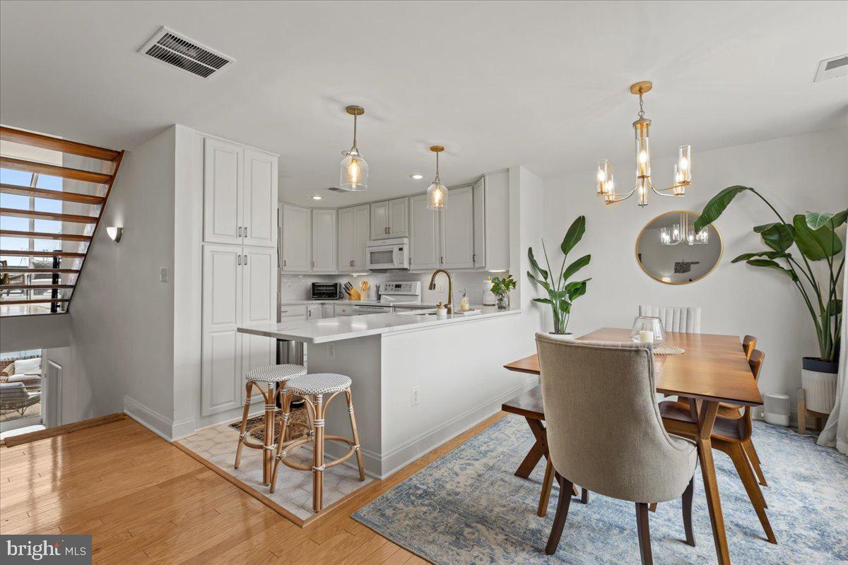 2409 Boston Street Baltimore, MD 21224 - Photo 23 of 46 a kitchen with a table and chairs in it
