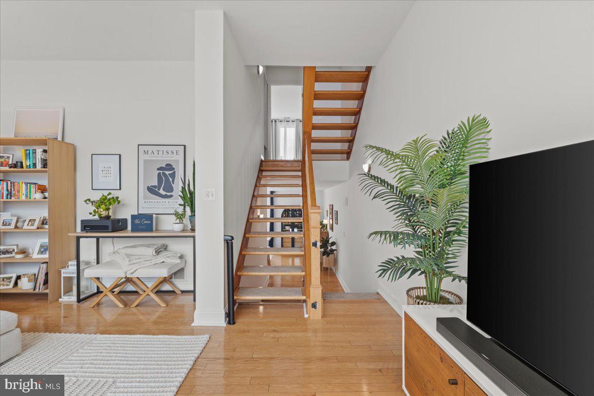 2409 Boston Street Baltimore, MD 21224 - Photo 30 of 46 a view of entryway with stairs and wooden floor