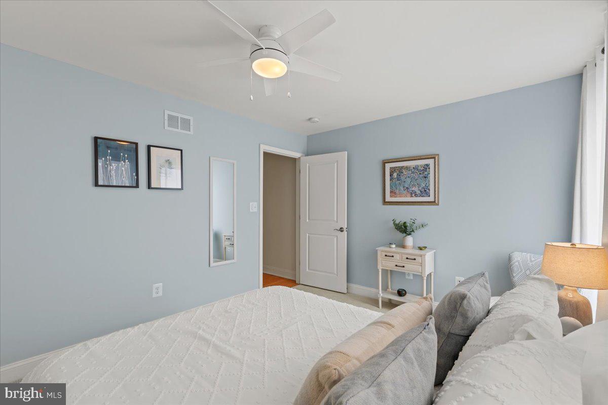 2409 Boston Street Baltimore, MD 21224 - Photo 40 of 46 a bedroom with a bed and painting on the wall