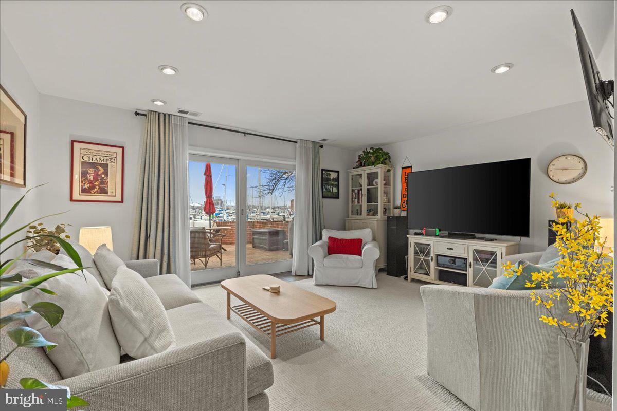 2409 Boston Street Baltimore, MD 21224 - Photo 6 of 46 a living room with furniture and a flat screen tv