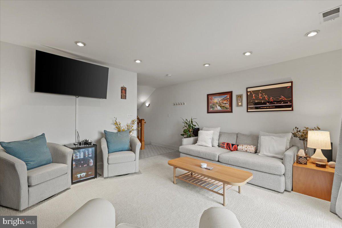 2409 Boston Street Baltimore, MD 21224 - Photo 8 of 46 a living room with furniture and a flat screen tv