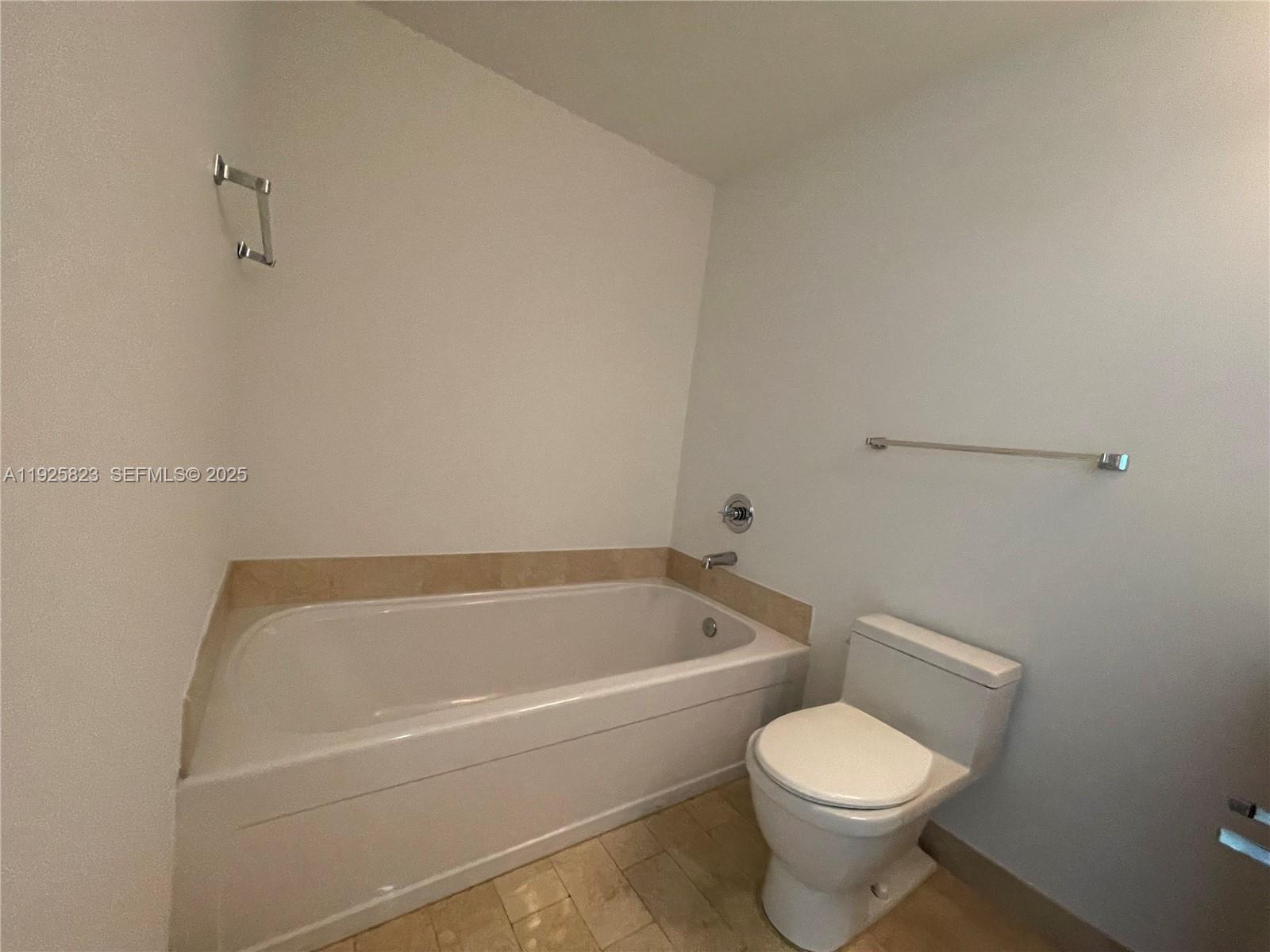 1111 Southwest 1st Avenue, Unit 2524N Miami, FL 33130 - Photo 11 of 11 a white bath tub sitting next to a white toilet