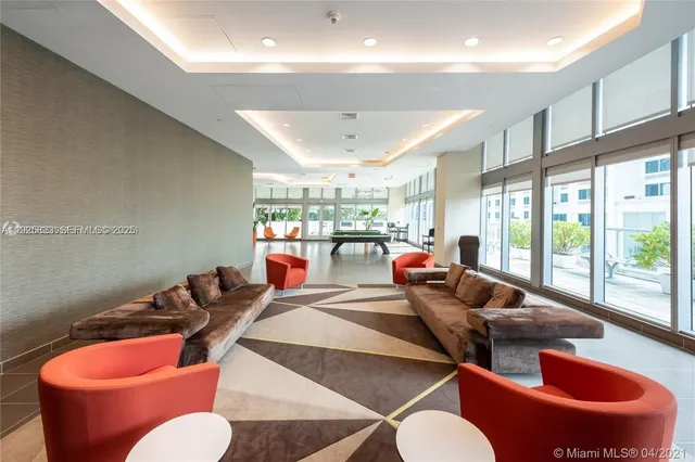 a living room with furniture a rug and white walls