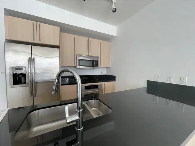 a bathroom with a shower a mirror and a sink