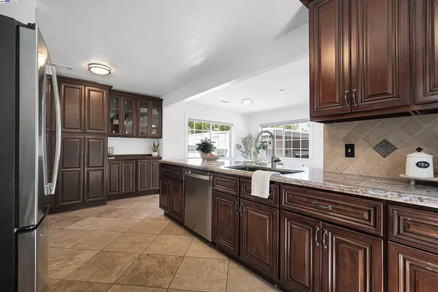 a kitchen with stainless steel appliances granite countertop a stove and a microwave